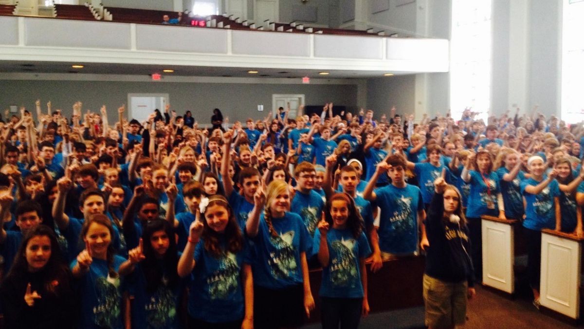 A packed auditorium of students at an ESW1 assembly