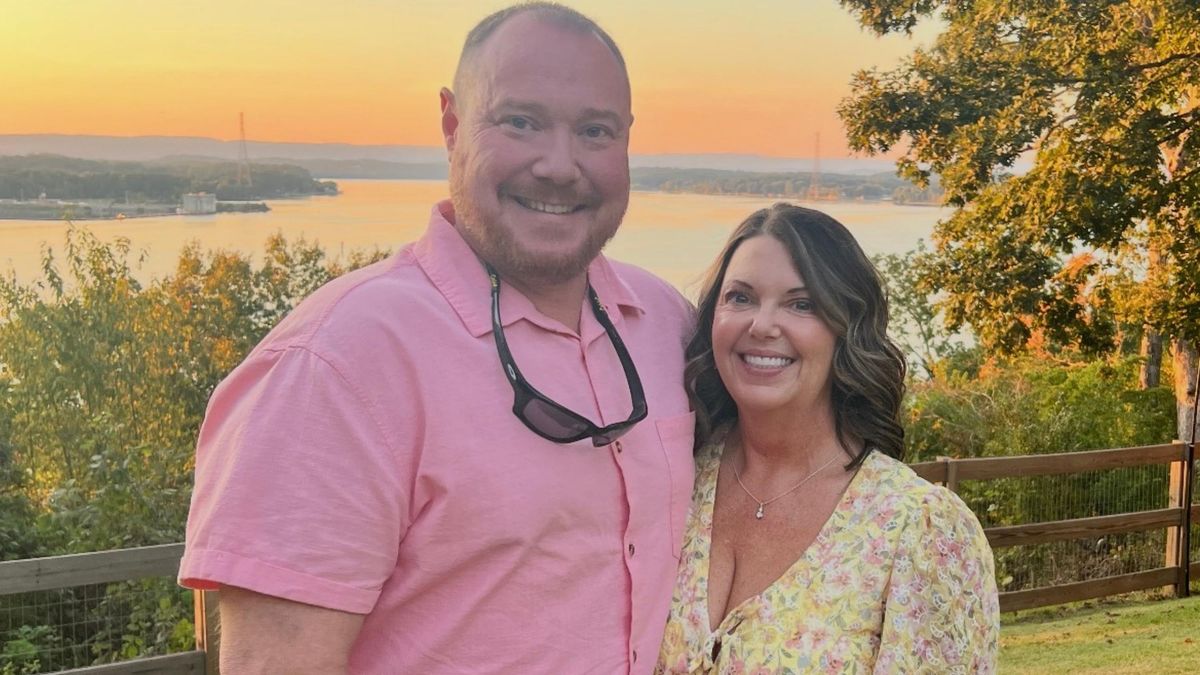 Tina and her husband at sunset by the lake