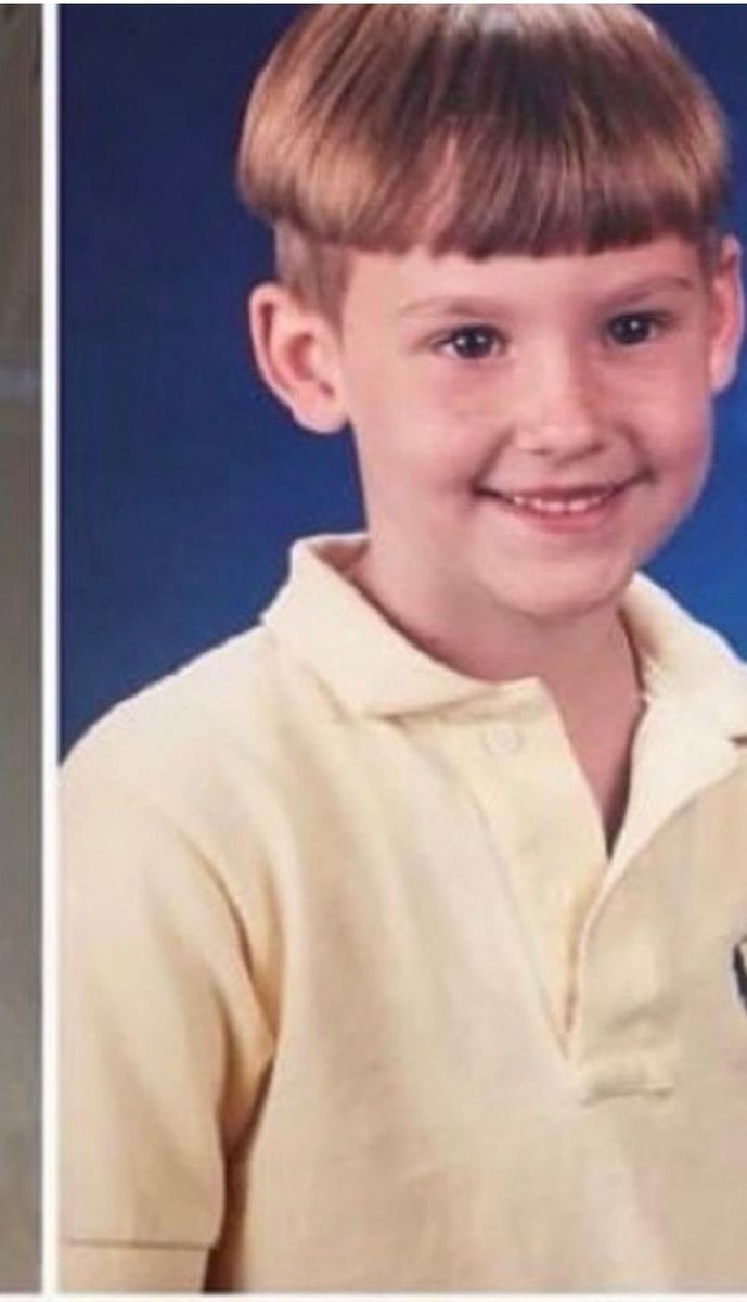 Young Tyler's school portrait in a yellow polo shirt